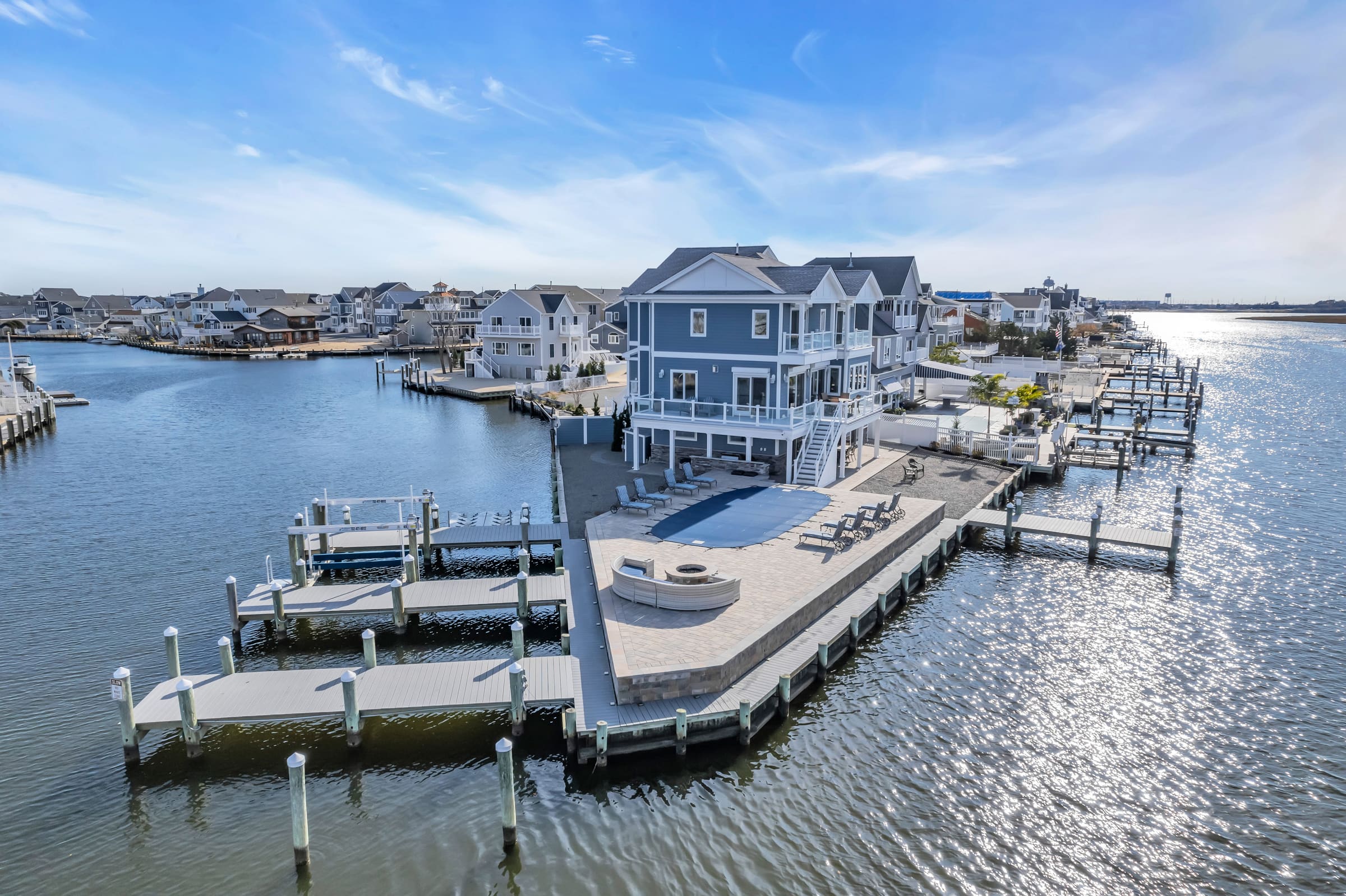 Aerial view of a JJC-built bayfront home with private docks and pool deck