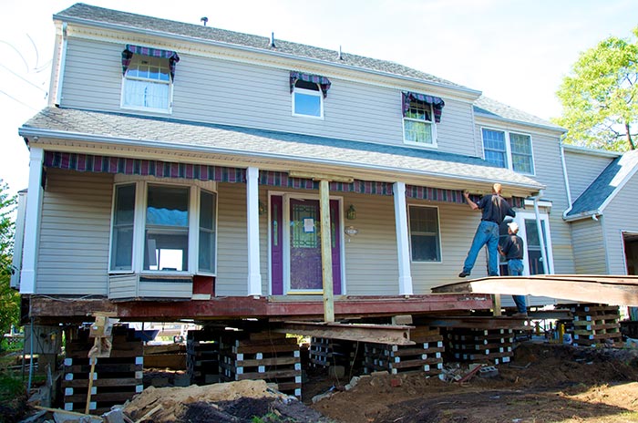 Steel I-beams installed under a Point Pleasant house, supported by wood cribbing